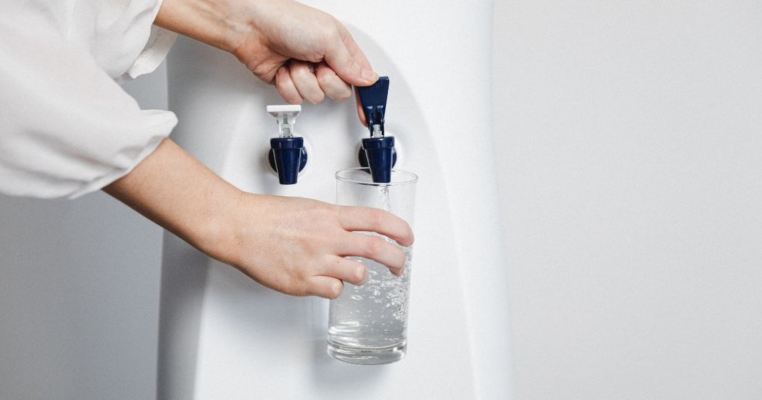 Filling cup with delicious filtered water using a Just Water cooler
