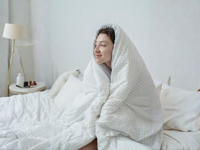 Cold morning with woman wrapped in duvet