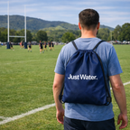 Man on the field with a Just Water Drawstring Back Pack